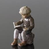 Boy, sitting reading, figurine