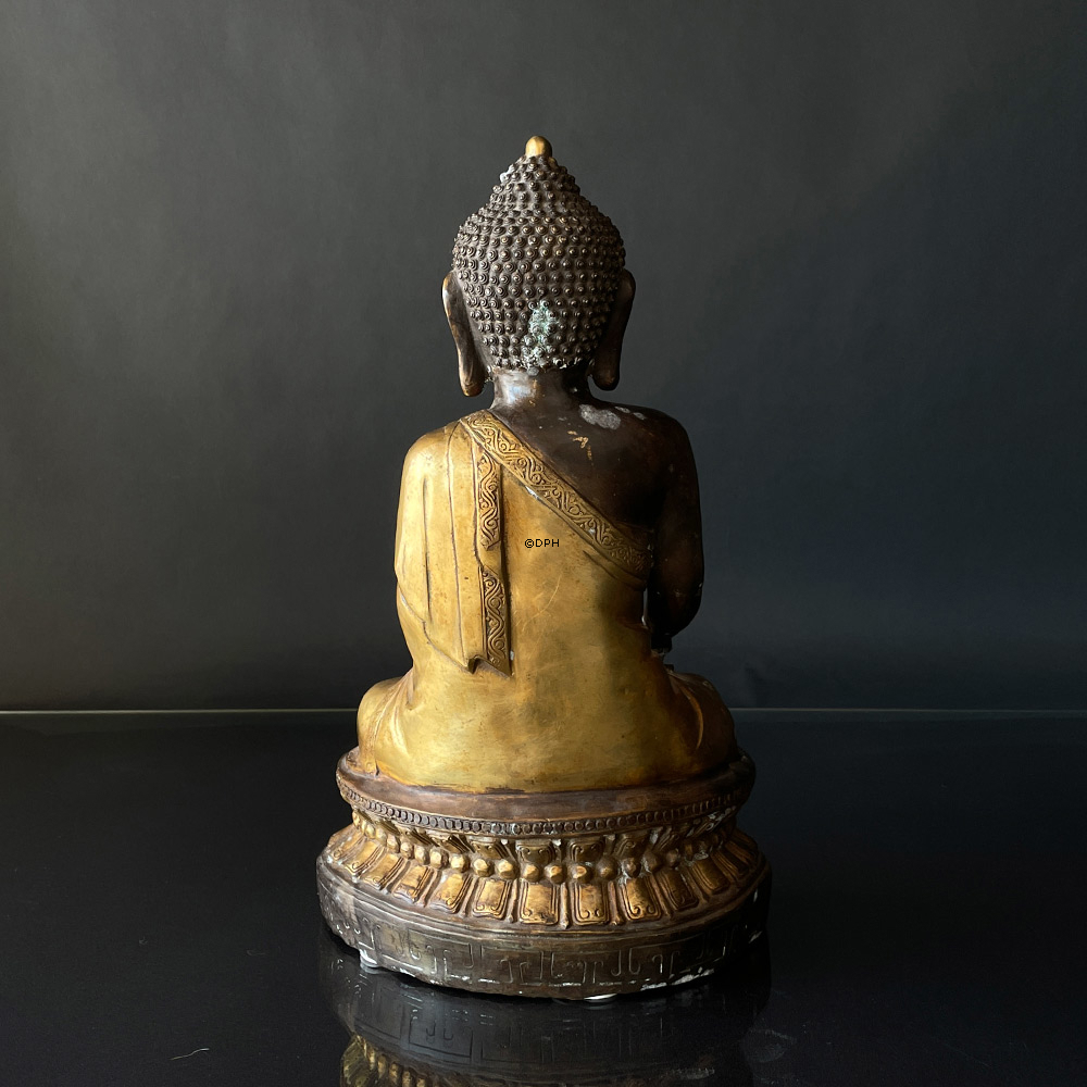 Buddha figure in brown and golden paint