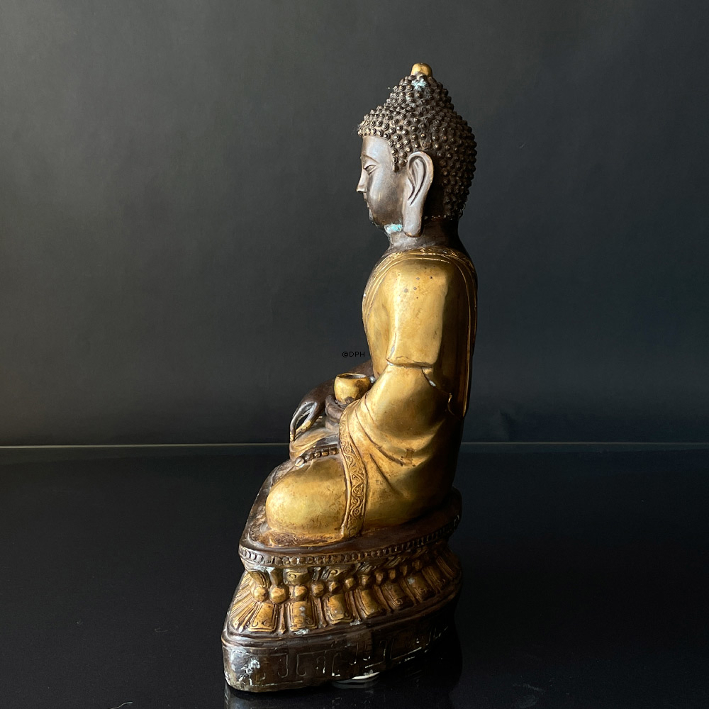 Buddha figure in brown and golden paint