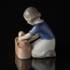 Girl with doll, gently putting it into the basket, Bing & Grondahl figurine No. 2307 | No. B2307 | DPH Trading