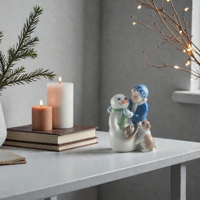Royal Copenhagen figure Else building a snowman stands on a sideboard with spruce in a vase, candles, and small warm Christmas lights.