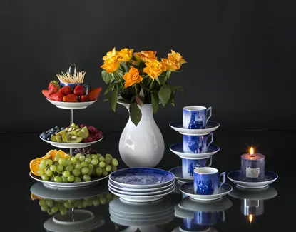 Royal Copenhagen cake stand with a cup at the to