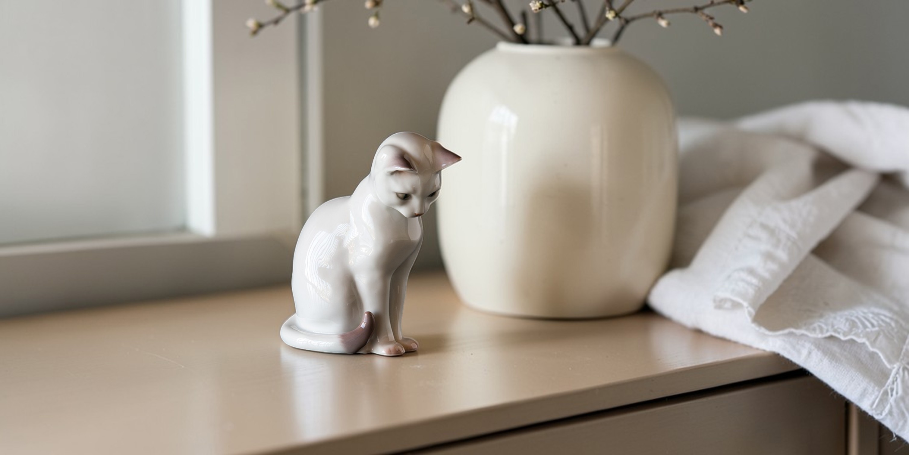 White cat figure in porcelain from Bing & Grøndahl, no. 2476, classic Danish porcelain cat sitting on a table in home decor