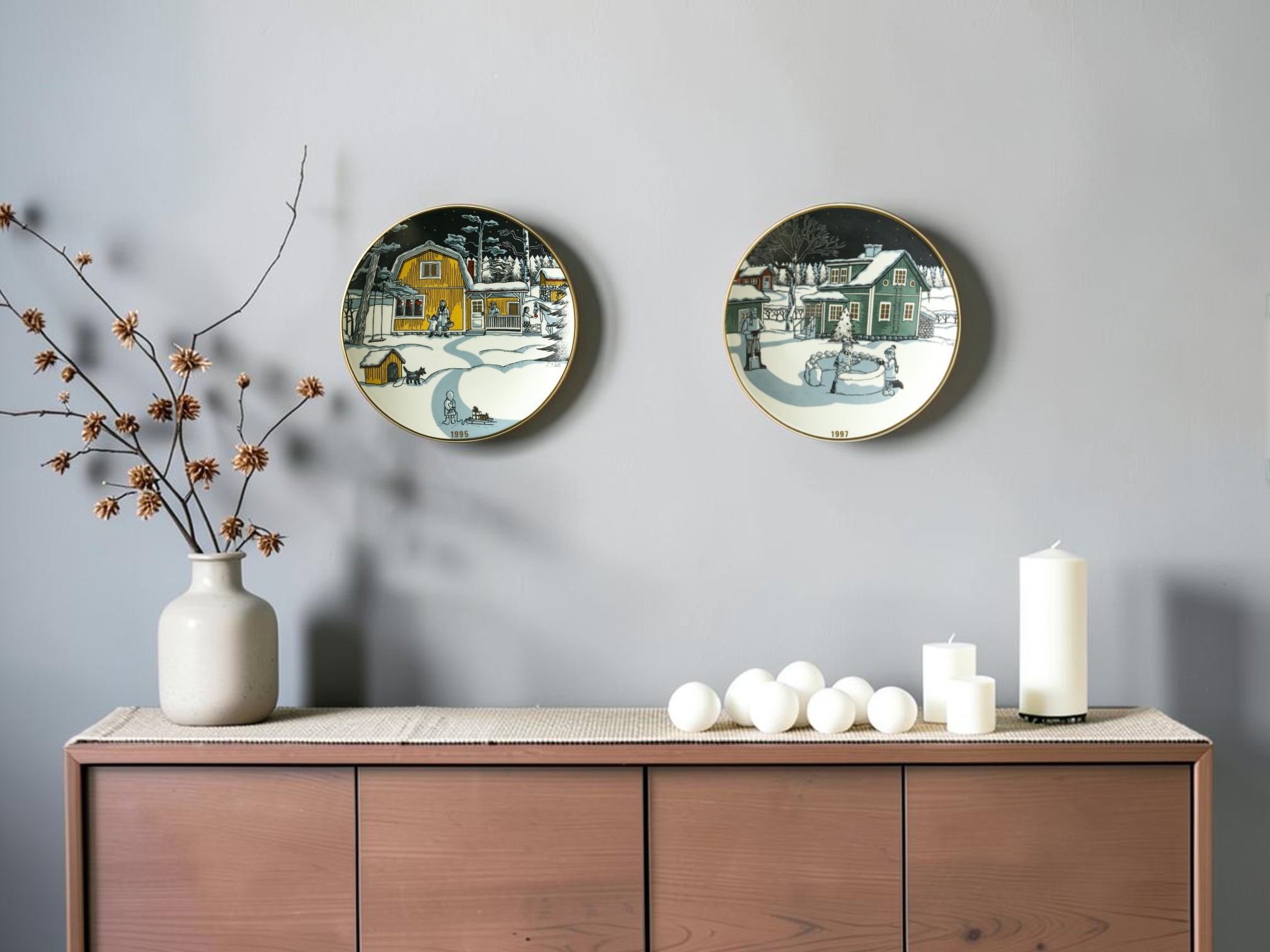 Arabia Christmas plates with winter motifs hung on gray wall above sideboard