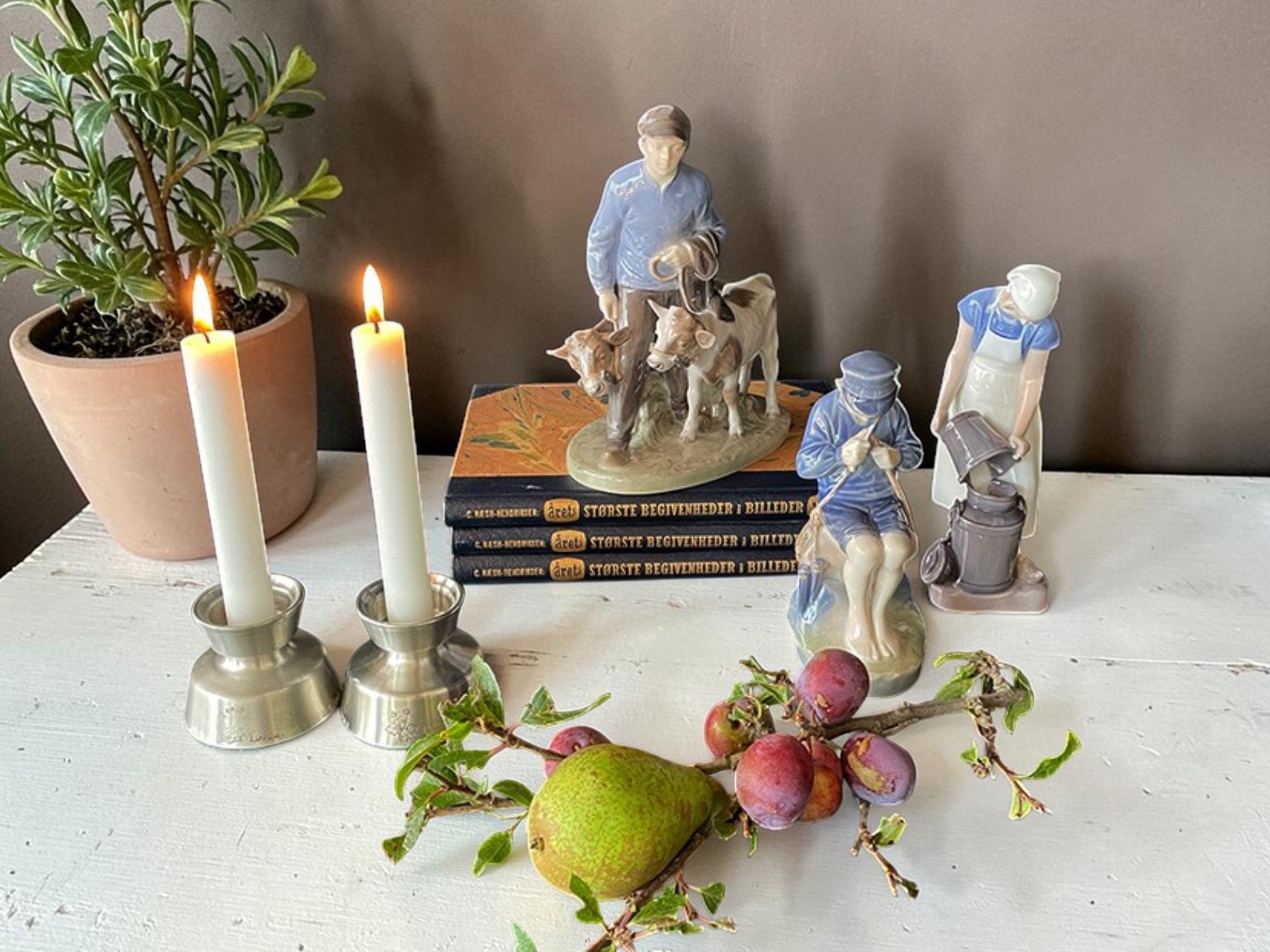 Boy with two calves, Royal Copenhagen figure, with other farm figures, candlesticks and old books.