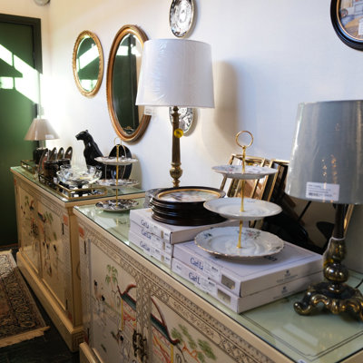 Display at the Danish Porcelain House with cake stands, lamps, mirrors, and decorative furniture – one of many inspiring corners in the store filled with home accessories and interior finds.