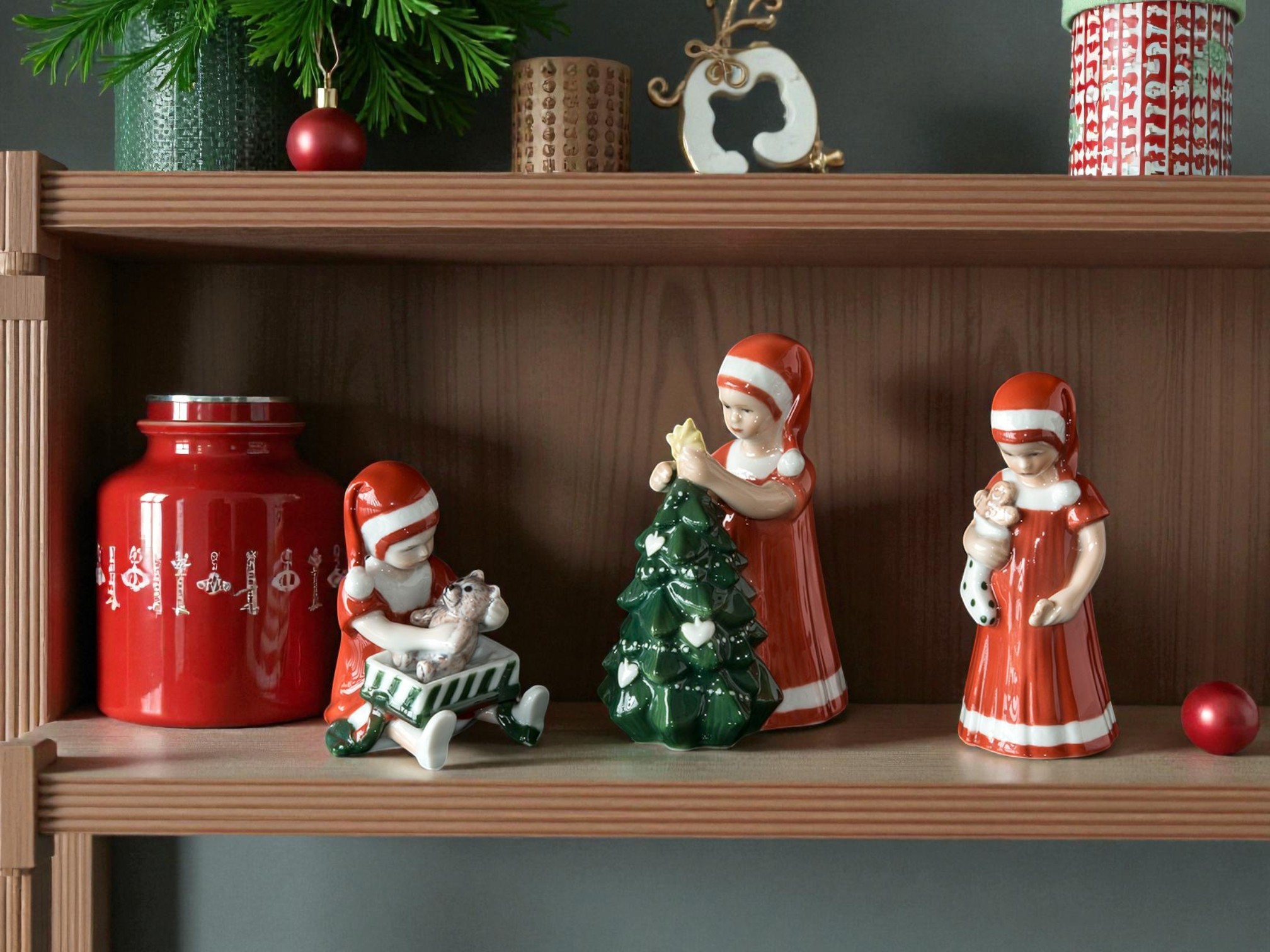 Royal Copenhagen Christmas with Else figurines on a shelf.