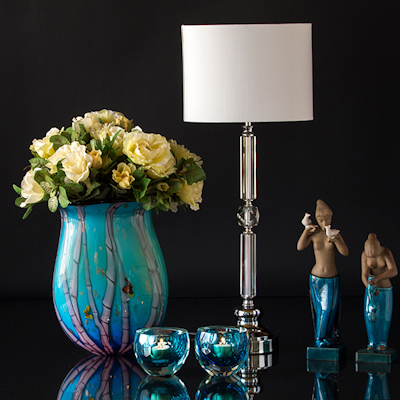 Blue glass vase with tealight candle holders and lamp with two figures