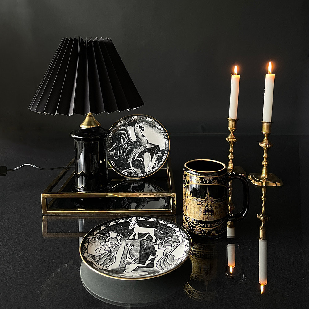 Bring your decorations together with a square serving tray with black glass in a golden finish
