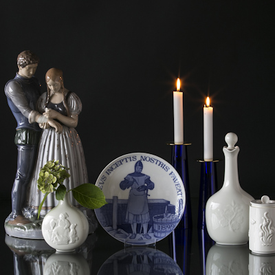 Figure of maiden and knight next to a freemason plate and Royal Copenhagen jars