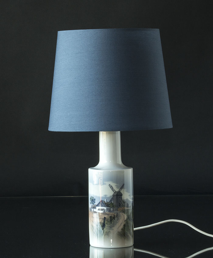 Round lampshade in blue on a porcelain lamp