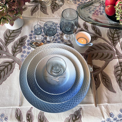 Table setting for three courses with Bing & Groendahl Seagull service without gold, Holmegaard drinking glasses, and an old Seagull mocha cup repurposed as a candleholder.