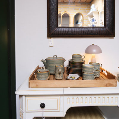 Stoneware coffee set with jugs, cups, saucers, and plates displayed on a tray at the Danish Porcelain House store in Odense, Denmark.