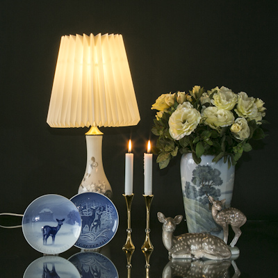 Christmas plates with deer together with figures of deer and landscape vase