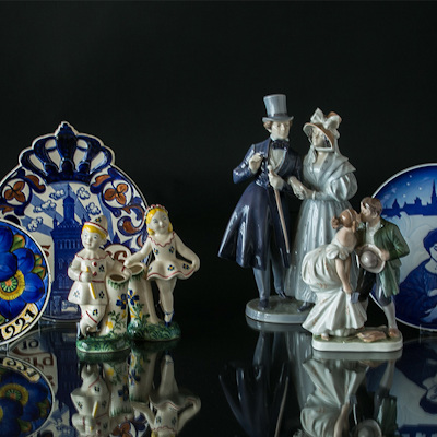 Aluminia children's aid figures and plates next to Royal Copenhagen figures and plate
