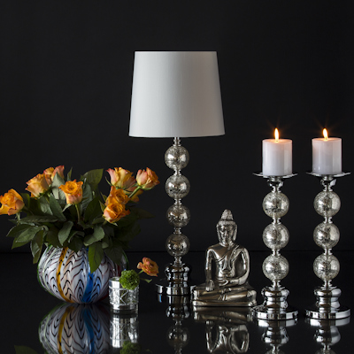 Colorful glass vase with buddha, lamp and candlesticks