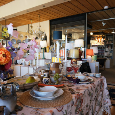 Inspiration table at the Danish Porcelain House in Odense, Denmark, set with mixed dinnerware, home décor, and flowers – a creative mix of new, old, and repurposed items.