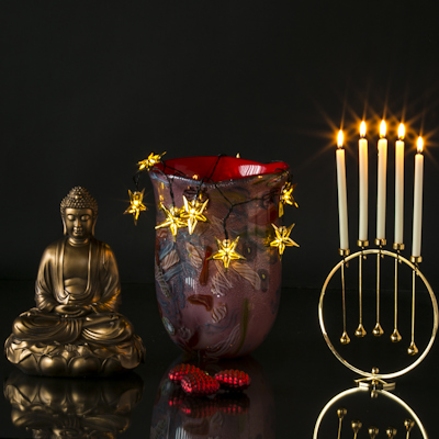 Large Buddha together with red glass vase and Asmussen candle holders on round tray