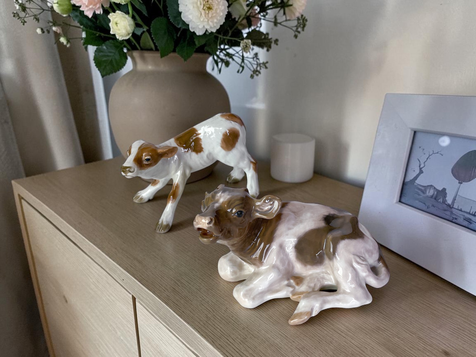 Two calf figures on sideboard
