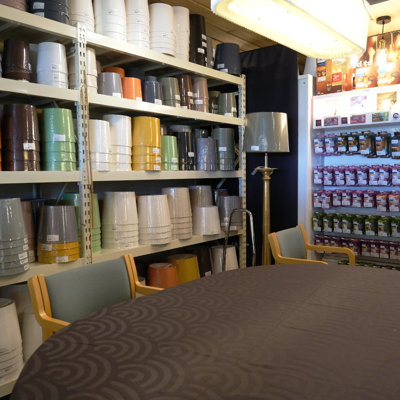 Shelves filled with lampshades in many colors and sizes at the Danish Porcelain House – combined with a cozy customer service area for personal guidance.